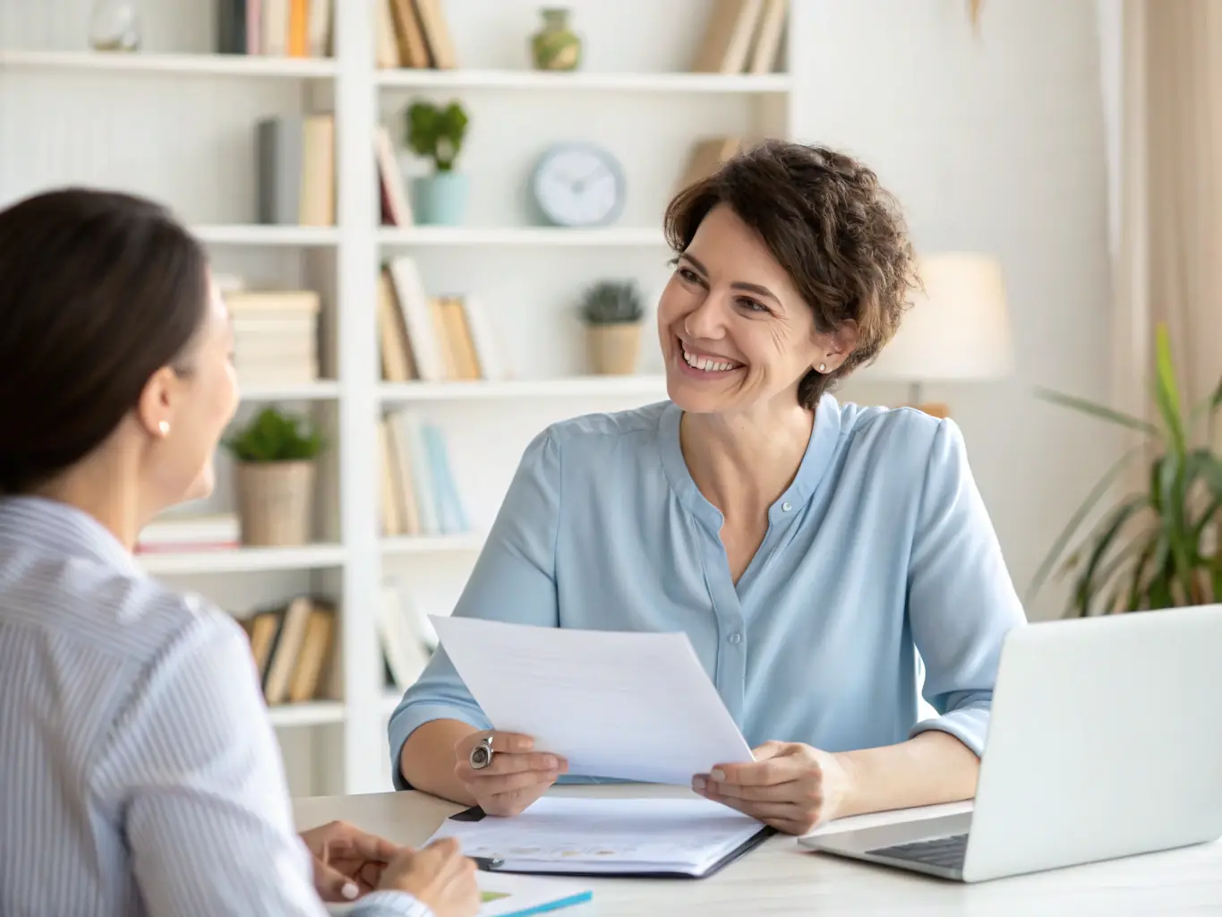 A serene image depicting a naturopathic doctor consulting with a client in a sunlit, plant-filled office, emphasizing personalized care and natural healing.